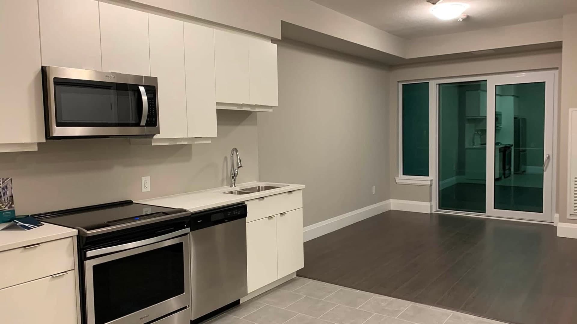 Empty GTA apartment kitchen and living area after a move-out clean by Pro City Maids